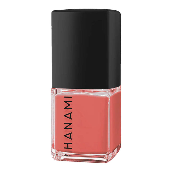 Nail polish bottle with black cap and coral colour on a white background.